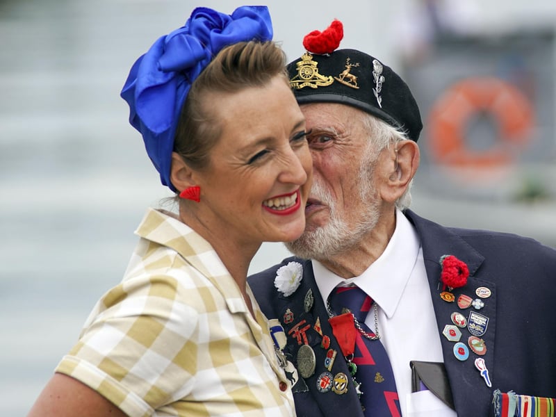 D-Day veteran Joe Cattini kisses a member of the Charlalas as he and other veterans are welcomed to the Portsmouth Historic Dockyard to commemorate the 77th anniversary of the Normandy Landings. Picture: Steve Parsons/PA Wire