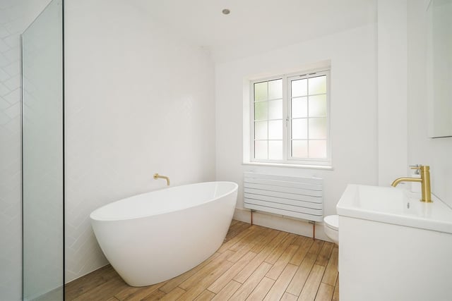 The family bathroom is beautifully finished with it's walk-in shower and standing bath. It's a fantastic space for the whole family to use to get ready.
