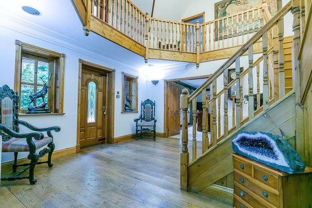 As you enter Loxley Lodge, you are greeted by this spectacular, double-height reception hall, with hardwood flooring. It has a split staircase, leading to a galleried landing.