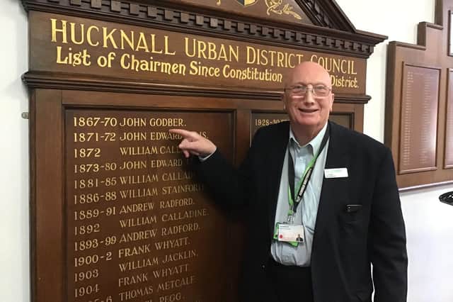 Hucknall councillor John Wilmott with the information board showing the first chairman of the Hucknall Urban District Council in 1867-1870, John Godber who the centre is named after
