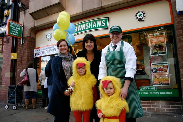 Crawshaws, family butchers at Lower Pavements, Chesterfield kids contest for Children in Need. From left:  Local shoppers Janet Dickens and Caroline Cooper, Crawshaws store manager Mike Sherry, Crawshaws ‘chickens’ Alex and Lucas Dickens pictured in 2009
