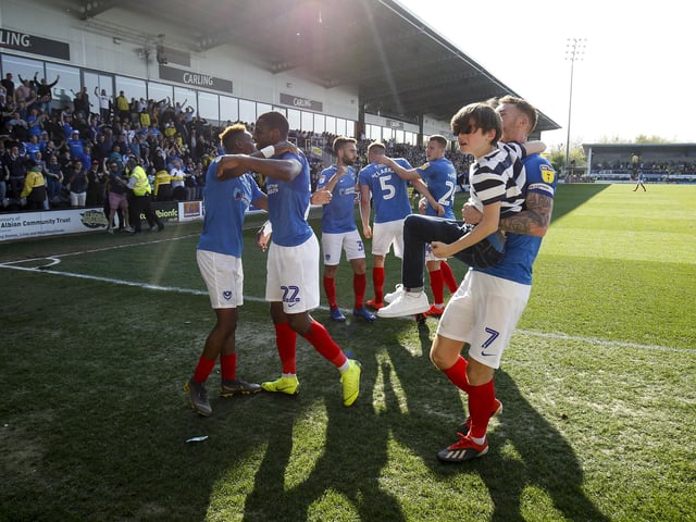 Tom Naylor carries a young Pompey fan off the pitch after celebrating
