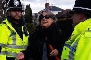 One woman being arrested for blowing a toy horn at tree protest 