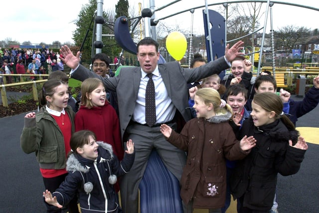 Sheffield Eagles Mark Aston and children from Hatfield and Hucklow Infant and Junior Schools in the new children's playground at Firth Park bakc in 2004