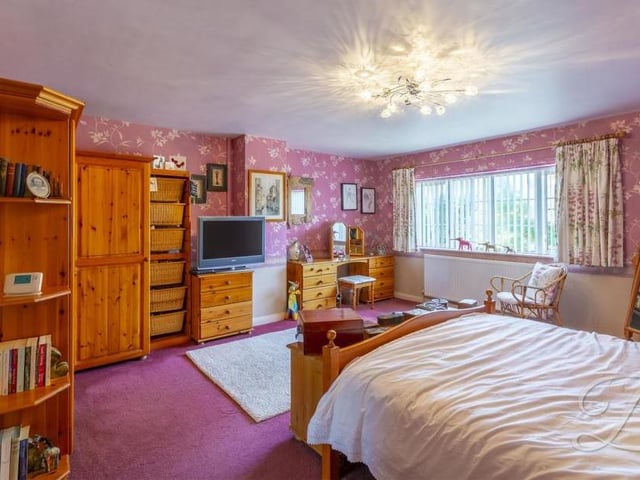 Upstairs now and a look at the main bedroom. It has a carpeted floor, central-heating radiators, a fitted wardrobe, a window to the front and access to an en suite.