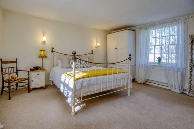 The master bedroom is dual aspect and connects to an en-suite bathroom with a free-standing slipper bath, double-sized shower and twin basins overlooking the gardens