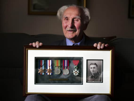 Jim Pass recalling his extaordinary war time service at his home in Sheffield. Picture Scott Merrylees