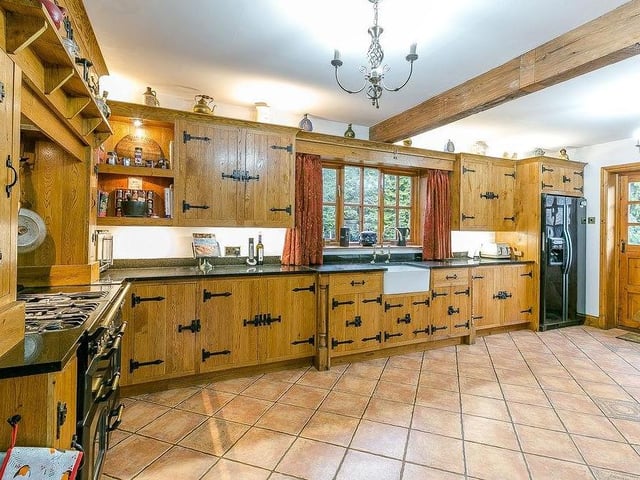 Marvel at this bespoke breakfast-kitchen. It features hand-made cabinets and units, a ceramic sink, a granite worktop and walk-in larder.
