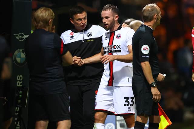 Paul Heckingbottom, manager of Sheffield United checks on Rhys Norrington-Davies: David Klein / Sportimage