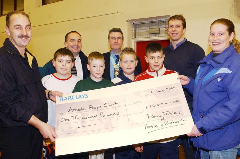 Philip Ginger, of Amble and Warkworth Round Table, presents a cheque to Amble Boys Club in February 2004.