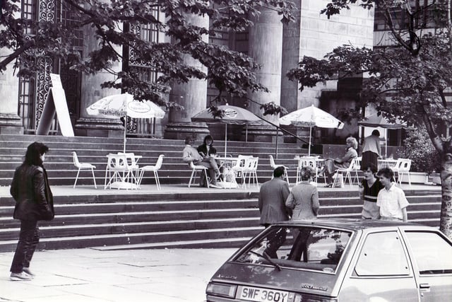 Paris in Sheffield!  The scene in Barkers Pool is reminiscent of Paris with the colourful parasols over the tables, as shoppers enjoy a cuppa outside Sheffield City Hall - 19th June 1985