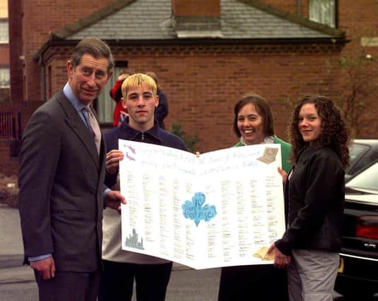 Prince Charles, as he was then, is presented with a huge birthday card from residents of the Manor estate in Sheffield on November 13, 1998, the day before he turned 50. Photo: Dean Atkins