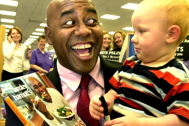 Popular TV Chef Ainsley Harriott was at WH Smith  in Meadowhall , to sign copies of his new book 'Low Fat Meals in Minutes'.Pictured is Ainsley with  2 years old Aidan Higham from Maltby