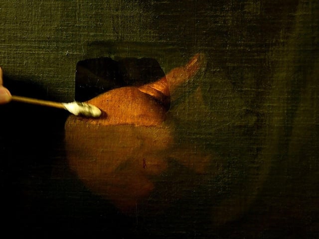 A close up of the painting of Simon the Zealot during cleaning