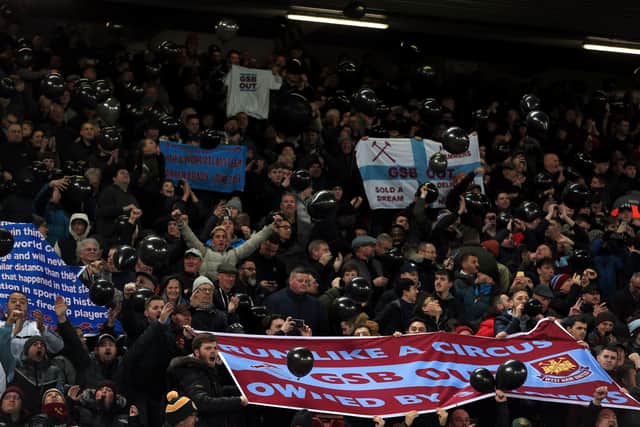West Ham United fans hold up banners in protest against co-owners David Sullivan and David Gold and vice-chairman Karren Brady during the Premier League match at Anfield, Liverpool.  Peter Byrne/PA Wire.