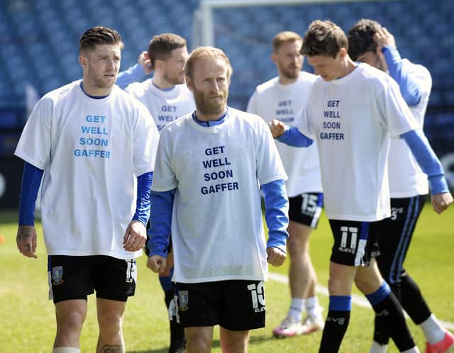 Sheffield Wednesday players with messages of support on their warm-up shirts for manager, Darren Moore, in hospital with Covid. (Pic Steve Ellis)