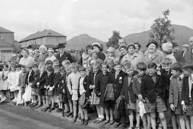 Young and old line the road to see the Queen and Duke of Edinburgh, July 1962.