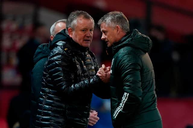 Manchester United boss Ole Gunnar Solskjaer congratulates his Sheffield United counterpart Chris Wilder after the Blades' 2-1 win at Old Trafford.  (Photo by TIM KEETON/POOL/AFP via Getty Images)