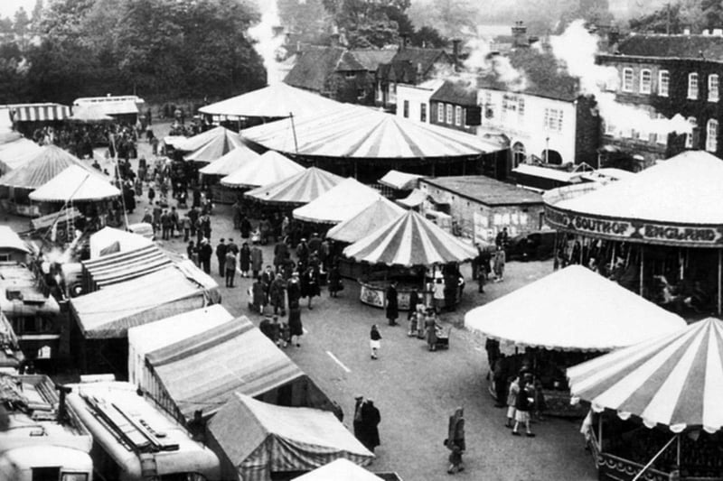 Wickham Fair circa 1946. Steam gallopers (roundabouts) make up all the fun of the fair in this travelling showmens fair at Wickham circa 1946.