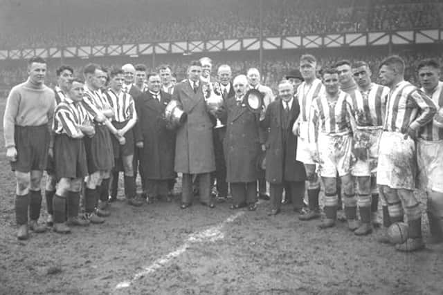 The Sunderland team is presented with the league trophy after becoming champions of England in 1936.