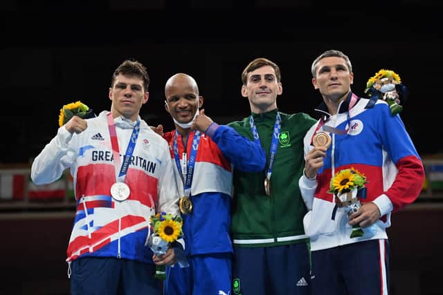 (LtoR) Second-placed Britain's Pat McCormack, gold medallist Cuba's Roniel Iglesias, bronze medallists Russia's Andrei Zamkovoi and Ireland's Aidan Walsh, celebrate on the podium after the men's welter (63-69kg) boxing final bout during the Tokyo 2020 Olympic Games at the Kokugikan Arena in Tokyo on August 3, 2021. (Photo by Luis ROBAYO / POOL / AFP) (Photo by LUIS ROBAYO/POOL/AFP via Getty Images).