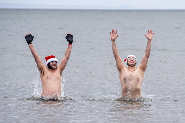 Christmas spirit kept high at Portobello Beach as swimmers Ross McNulty and Gareth Rudd celebrate braving the cold waters on December 25.