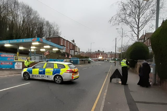 Police explain the cordon to a resident on Burngreave Road, Sheffield