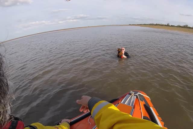 Dad-of-three Richard Burton desperately tried to hold his pet pooch, Lola, above rising water after getting caught out by the tide on a walk (Photo: SWNS)
