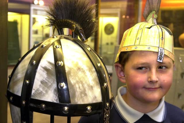 A schoolboy with a paper replica of the Benty Grange helmet in Sheffield. Picture: Chris Lawton.