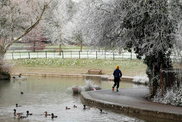 NORTHAMPTON, ENGLAND - DECEMBER 08:  A jogger enjoying a morning run after a heavy frost at Abington Park on December 08, 2020 in Northampton, England . (Photo by David Rogers/Getty Images)