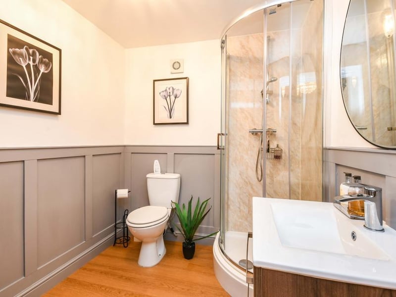 The ensuite accessed via the main bedroom/garden room has a heated towel rail, LVT flooring, part tiled walls and extractor fan. There is a single shower enclosure, WC and vanity sink with a mixer tap.