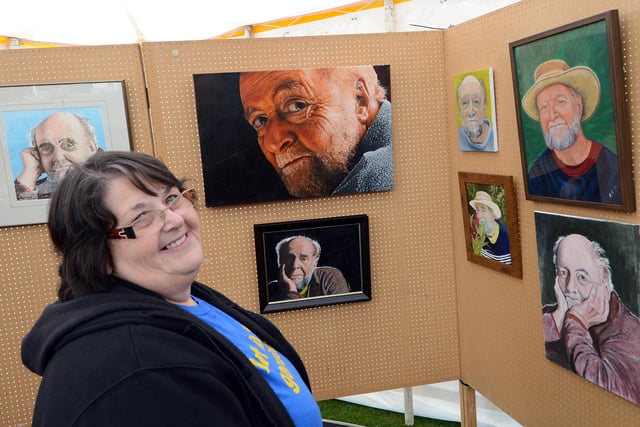 Barbara Morris, of Intake, a steward at the 2013 Art in the Gardens event, admiring some paintings of Roni Robinson.