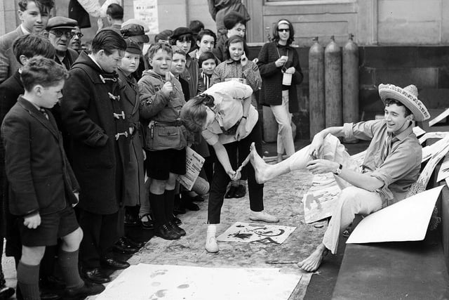 'Action painting' using feet as part of the Edinburgh University charities day on the steps of the Royal Scottish Academy on the Mound in April 1963.