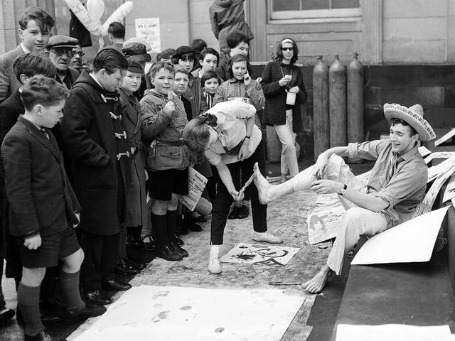 'Action painting' using feet as part of the Edinburgh University charities day on the steps of the Royal Scottish Academy on the Mound in April 1963.