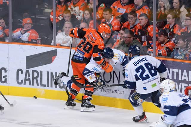Jonathan Phillips clashes on the boards at the Arena