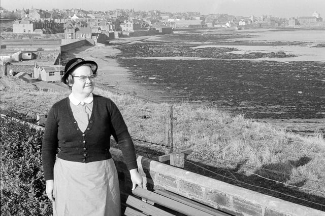 Local district Nurse Dunsire pictured with Dunbar in the background in February 1964.