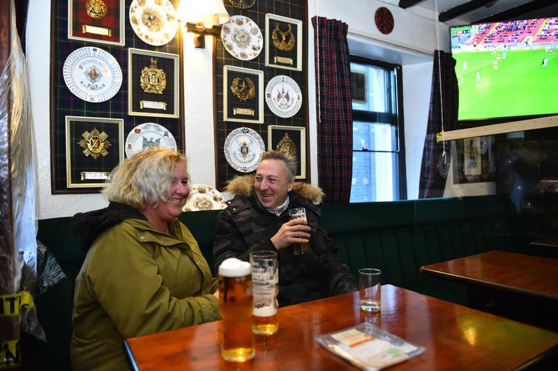 People enjoy a drink at The Swan Inn. (Photo by Nathan Stirk/Getty Images)