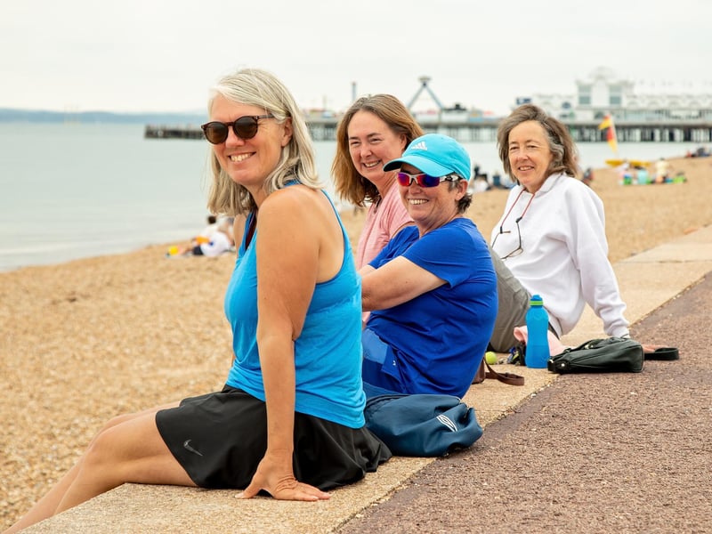 Tennis players Cressida Williams (55), Katy Bracher (56), Kate Gurl (49) and Nikki Scott (62) take a post-match rest on the seafront. Picture: Mike Cooter (150721)