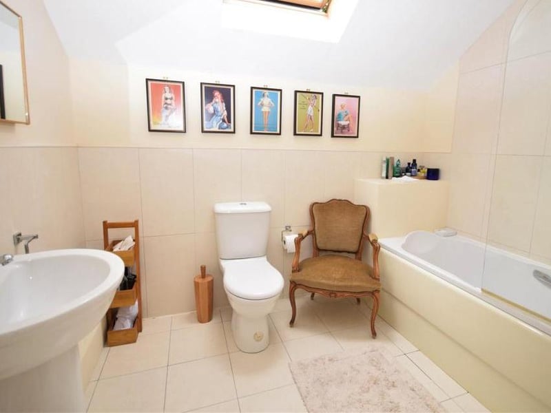 The bedroom suite, or annexe, has its own en suite, with panelled bath and shower over. It also has a low-flush WC, wash basin and heated towel-rail.