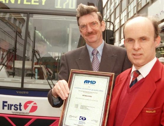 Bus driver Pete Fettis gets a certificate in 1999.