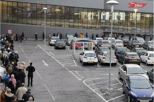 Shoppers queue outside Tesco on Spital Hill this morning (March 19). Photo: Ahmed Mohammed.