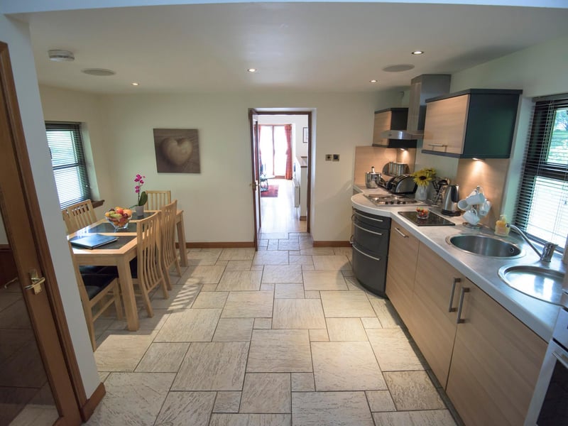 The roomy kitchen area has all mod cons and a comfortable dining area.