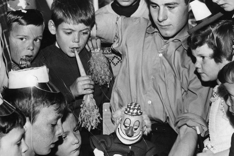 Fred Finch introduces one of his father's puppets to a group of children at a 1963 party held for them by the Westoe Mechanics Social Club in the Boldon Lane Community Centre.