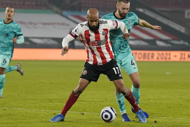 David McGoldrick of Sheffield United tussles with Nathaniel Phillips of Liverpool last season: Andrew Yates/Sportimage