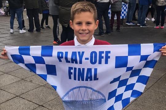 A young fan flies the flag for Pools!