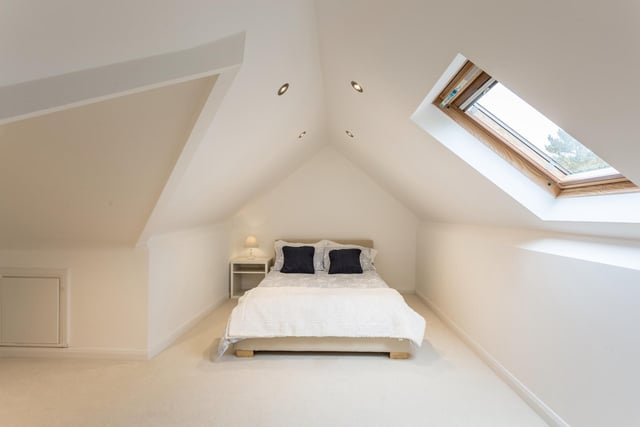 This bedrooms has a skylight and spotlights.