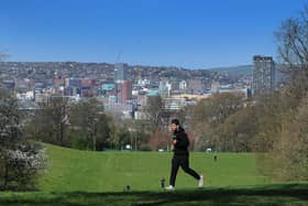 A runner is pictured in Norfolk Park, with Sheffield City Centre as a backdrop, as the Coronavirus outbreak continues. Picture by Simon Hulme