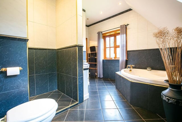 An impressive, large en suite bathroom to the main bedroom. It has a raised spa bath, walk-in shower and a design that can only be appreciated in person.
