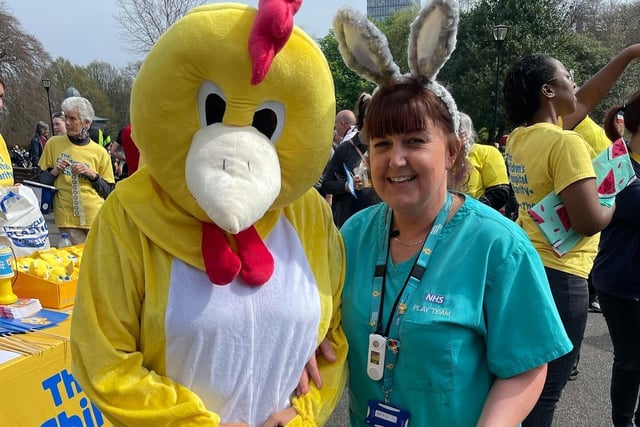 A mascot with a member of staff from the hospital.