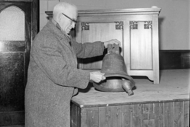 Mr James Orr inspects a bell at Granton Congregational Church in 1964.